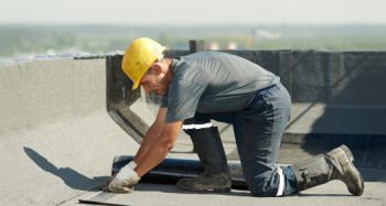 Handwerker dichten eine Gefälledämmung ab